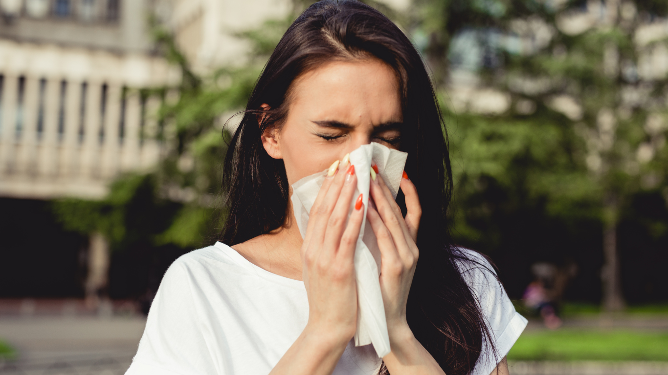 Woman with seasonal allergies outdoors